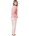Woman wearing a pink long-sleeve top and white pants