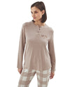 Woman wearing a beige long-sleeve top and checkered pants