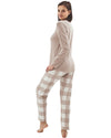 Woman wearing a beige long-sleeve top and checkered pants