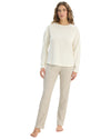 Woman wearing a white long-sleeve top and beige pants