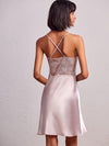 model wearing V-neck satin babydoll dress with intricate embroidery on the front and back.