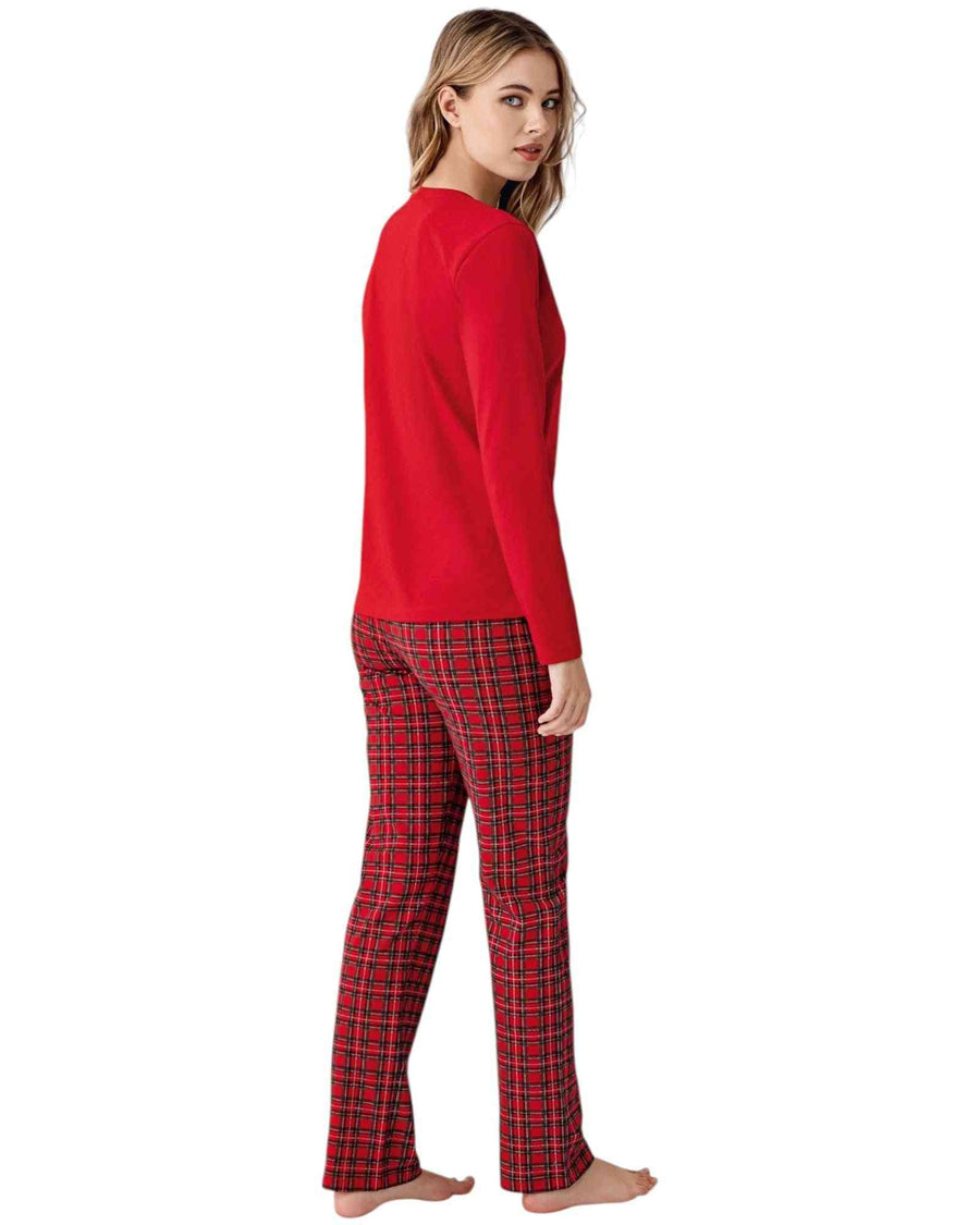 Woman wearing a red 'Happy New Year' pajama set with plaid pants