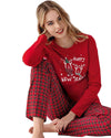 Woman wearing a red 'Happy New Year' pajama set with plaid pants