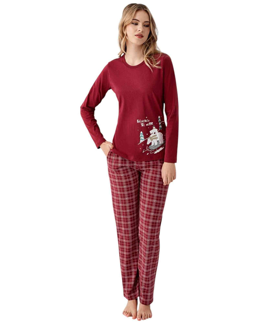 Woman wearing a red pajama set with a Christmas design
