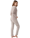 Woman wearing a long-sleeve top and striped pants 