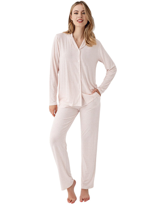 Woman wearing a light pink pajama set with mini dots