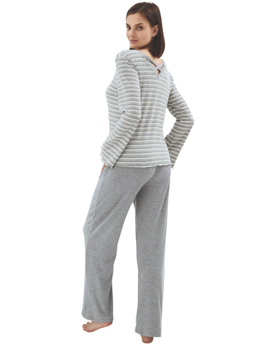 Woman wearing a gray striped long-sleeve top and pants
