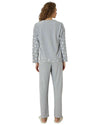 Woman wearing gray pajamas with star patterns 