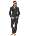 Woman wearing a black pajama set with pink heart pattern