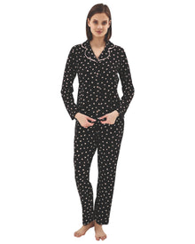  Woman wearing a black pajama set with pink heart pattern