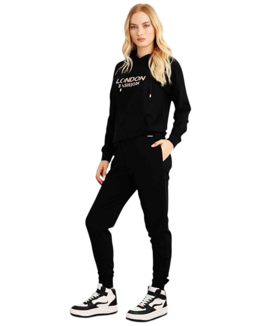 Woman wearing a black hoodie and pants with 'London Fashion' text