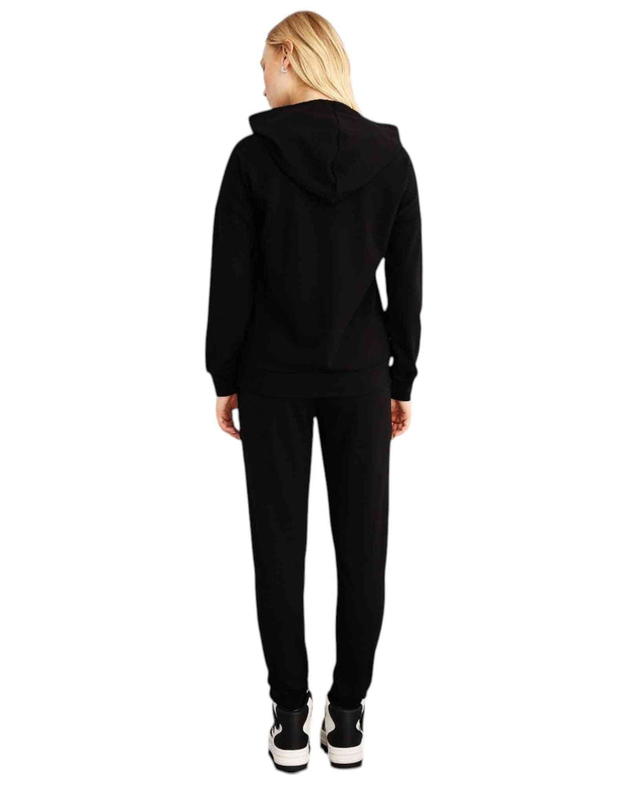 Woman wearing a black hoodie and pants with 'London Fashion' text