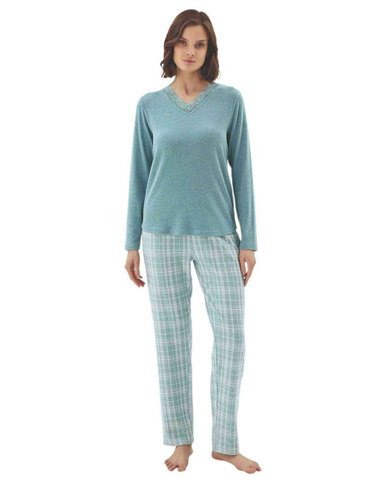 Woman wearing a teal long-sleeve top and plaid pants 