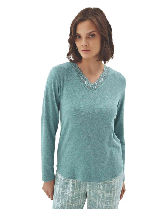 Woman wearing a teal long-sleeve top and plaid pants 