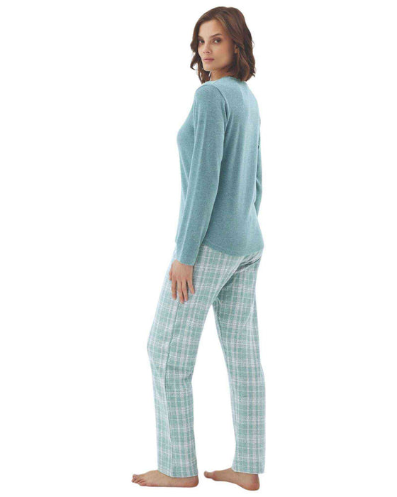 Woman wearing a teal long-sleeve top and plaid pants 