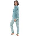 Woman wearing a teal cardigan and checkered pants 