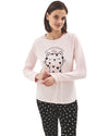 Woman wearing a pink long-sleeve top with cat print and black pants with hearts print 
