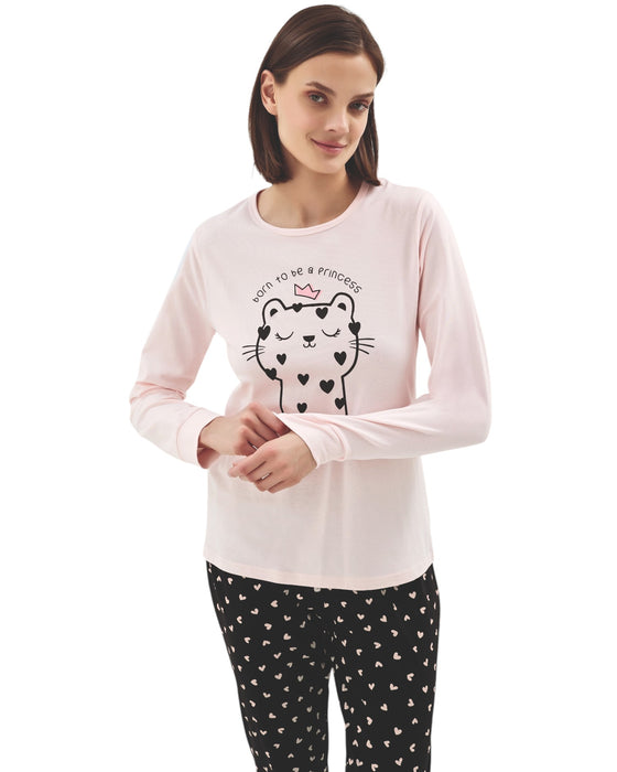 Woman wearing a pink long-sleeve top with cat print and black pants with hearts print 