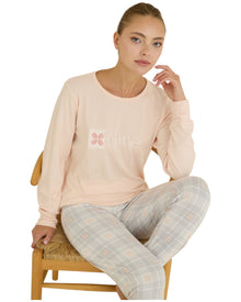  Woman wearing a light pink long-sleeve top and gray checkered pants 