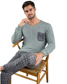  Man wearing a green long-sleeve shirt with a pocket and gray checkered pants