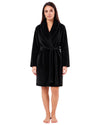 Woman wearing a black textured plush short robe with a shawl collar, long sleeves, and matching waist tie belt.