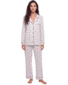 A woman modeling a two-piece pajama set with a white base and a small pink floral pattern, featuring a button-up long-sleeve top and matching pants