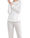 A model wearing a white long-sleeve pajama top with a cloud graphic and 'rainy morning' text, paired with light gray patterned pajama pants 