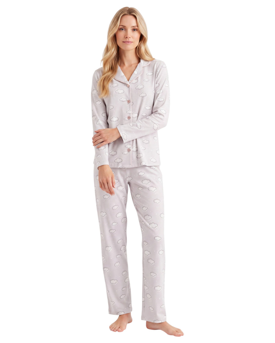 A woman modeling a two-piece pajama set with a light gray and white paisley pattern, featuring a long-sleeve button-up top and matching pants