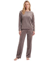 A woman modeling a two-piece long-sleeve pajama set in a dusty taupe color, featuring a matching top with subtle text and coordinating pants