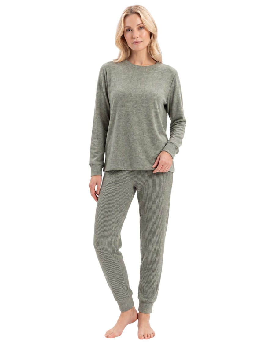 A woman modeling a matching two-piece loungewear set consisting of a long-sleeve crewneck top and jogger pants in a heathered sage green color