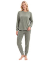 A woman modeling a matching two-piece loungewear set consisting of a long-sleeve crewneck top and jogger pants in a heathered sage green color