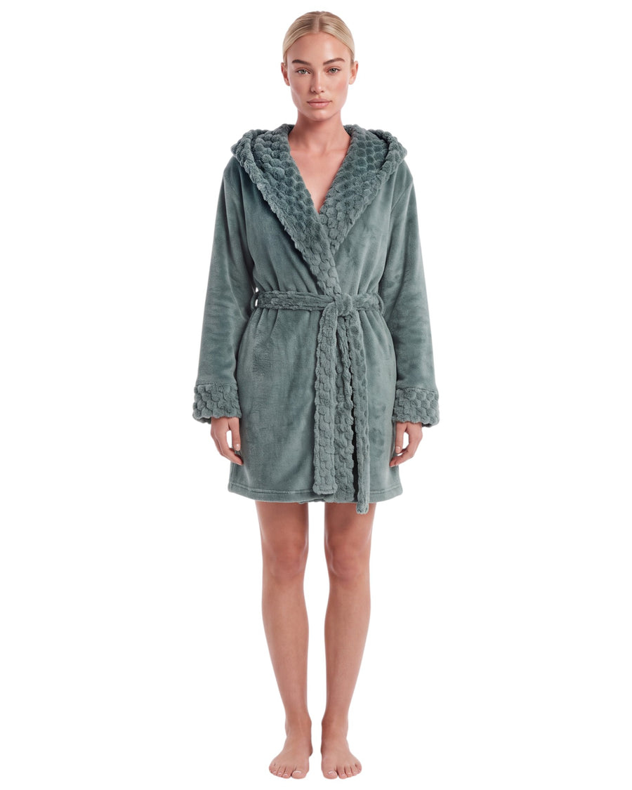 Woman wearing a sage green plush hooded short robe with textured trim, long sleeves, matching waist belt, and above-the-knee length.