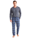 A man modeling a two-piece pajama set consisting of a dark gray long-sleeve V-neck shirt and blue plaid pajama pants with a drawstring waist