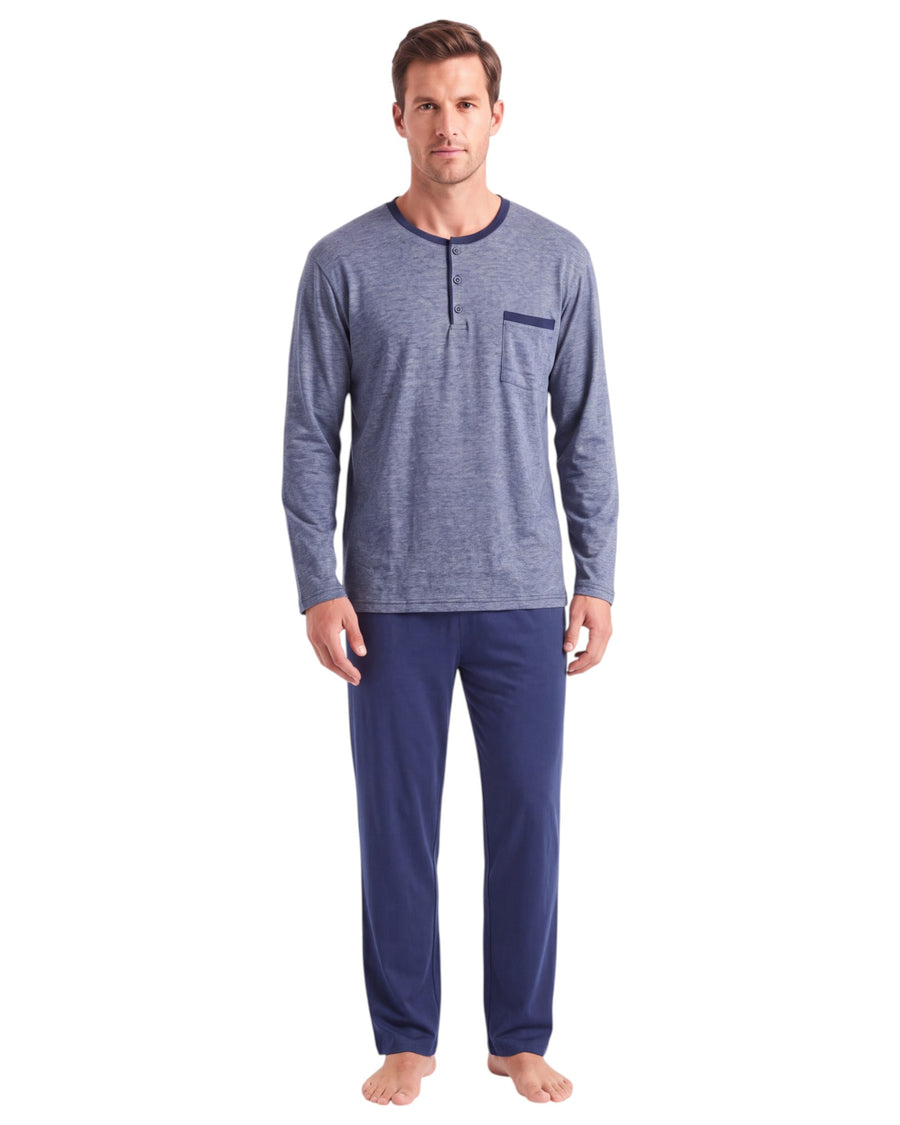 A man modeling a heathered blue long-sleeve henley shirt with a chest pocket and navy blue pants 