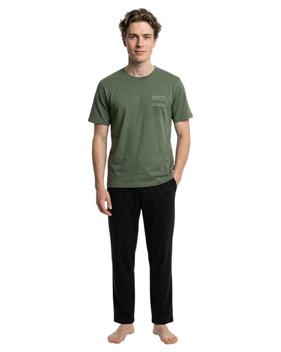 Man wearing a green t-shirt and black pants pajama set
