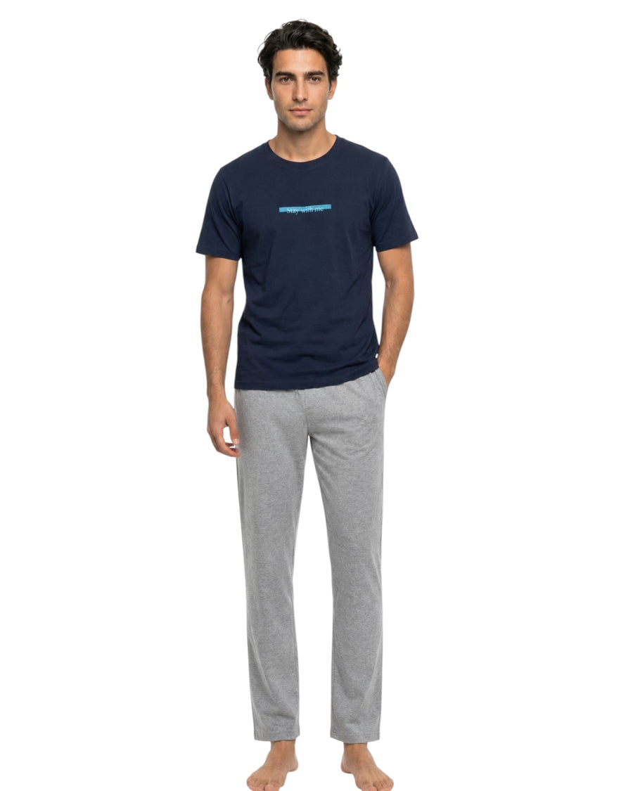 Male model wearing a navy lounge T-shirt with grey jogger lounge pants.
