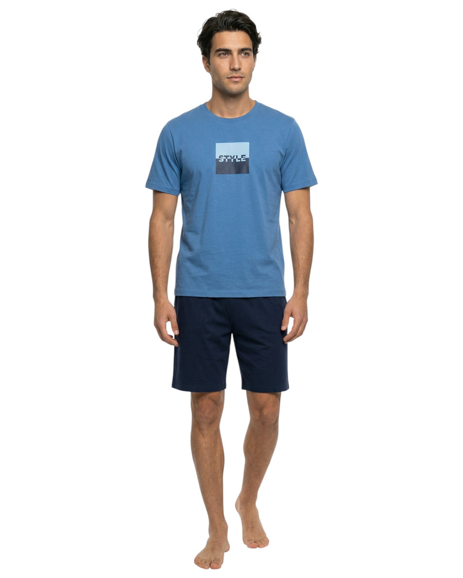 Male model wearing a blue graphic lounge T-shirt with navy lounge shorts.