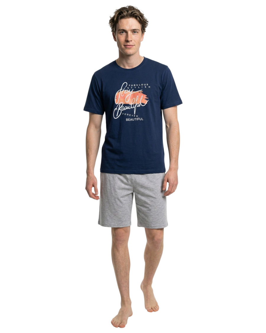 Man wearing a navy t-shirt with a graphic design and gray shorts 