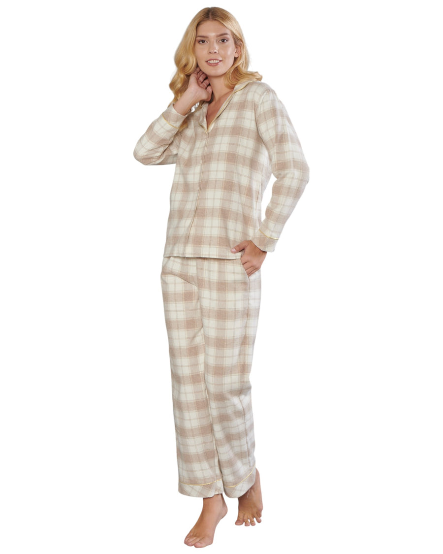Woman wearing a beige and brown plaid pajama set on a white background
