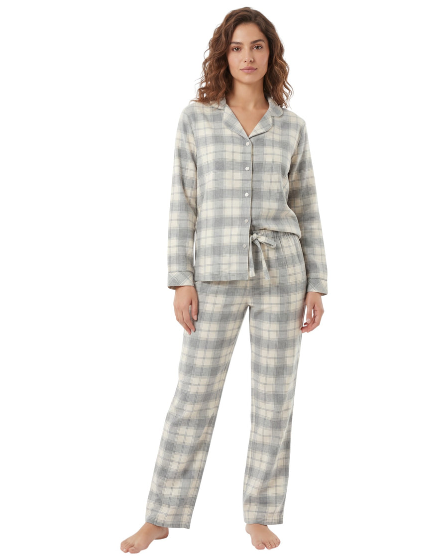 Woman wearing a gray and white plaid pajama set on a white background