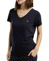 Woman wearing a navy t-shirt with a small logo, close up picture