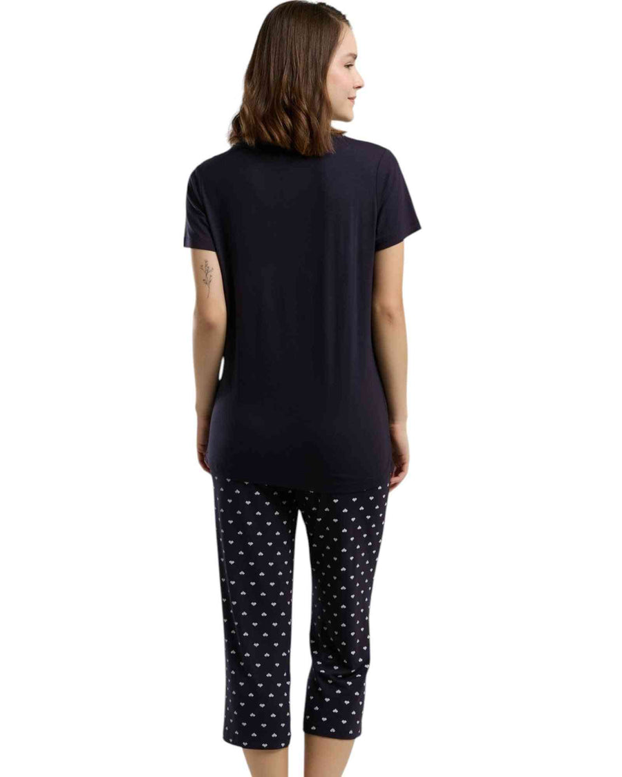 Woman wearing a navy blue t-shirt and black capri pants printed all over 