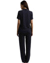 Woman wearing a navy blue printed pajama set