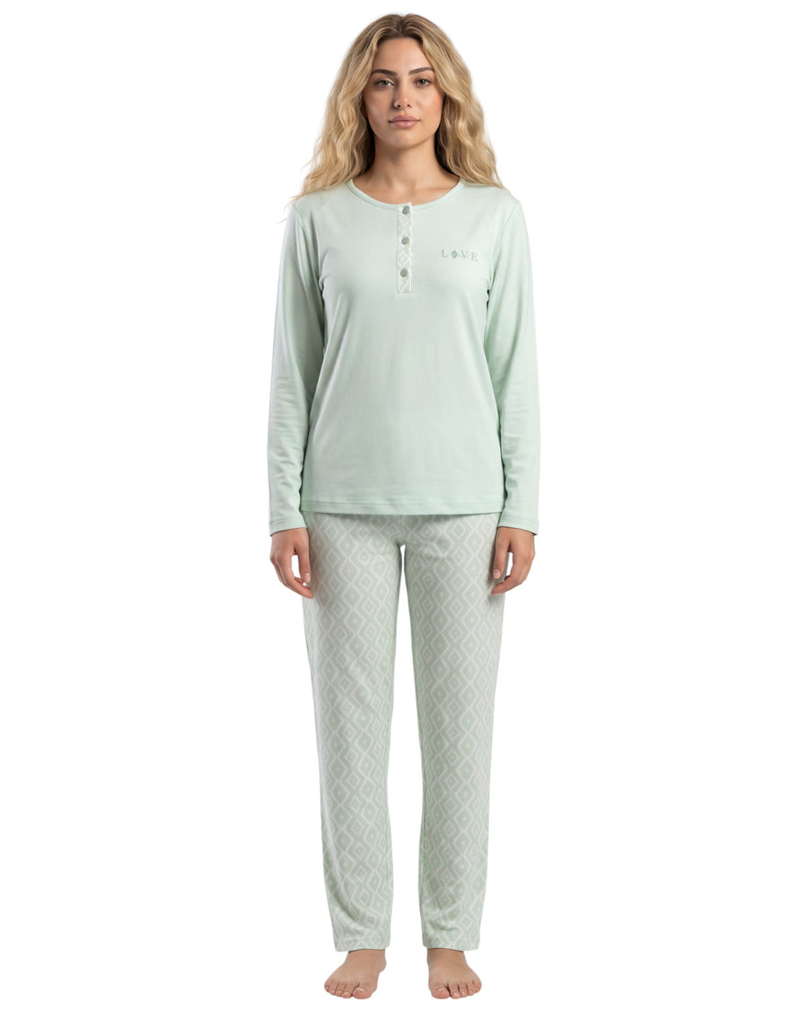 Woman wearing a light green long-sleeve top and pants on a white background