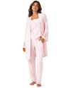 A woman modeling a light pink pajama set consisting of a matching robe, tank top, and pants