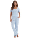 Women's light blue pajama set featuring a short sleeve lace-trim top with decorative buttons and matching full-length pants with side pockets.
