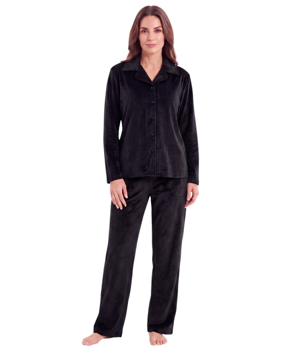 A woman modeling a black long-sleeve button-front pajama top with matching black pajama pants