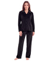 A woman modeling a black long-sleeve button-front pajama top with matching black pajama pants