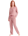 A woman modeling a two-piece waffle-knit pajama set in dusty rose pink, featuring a long-sleeve button-front cardigan and matching drawstring pants
