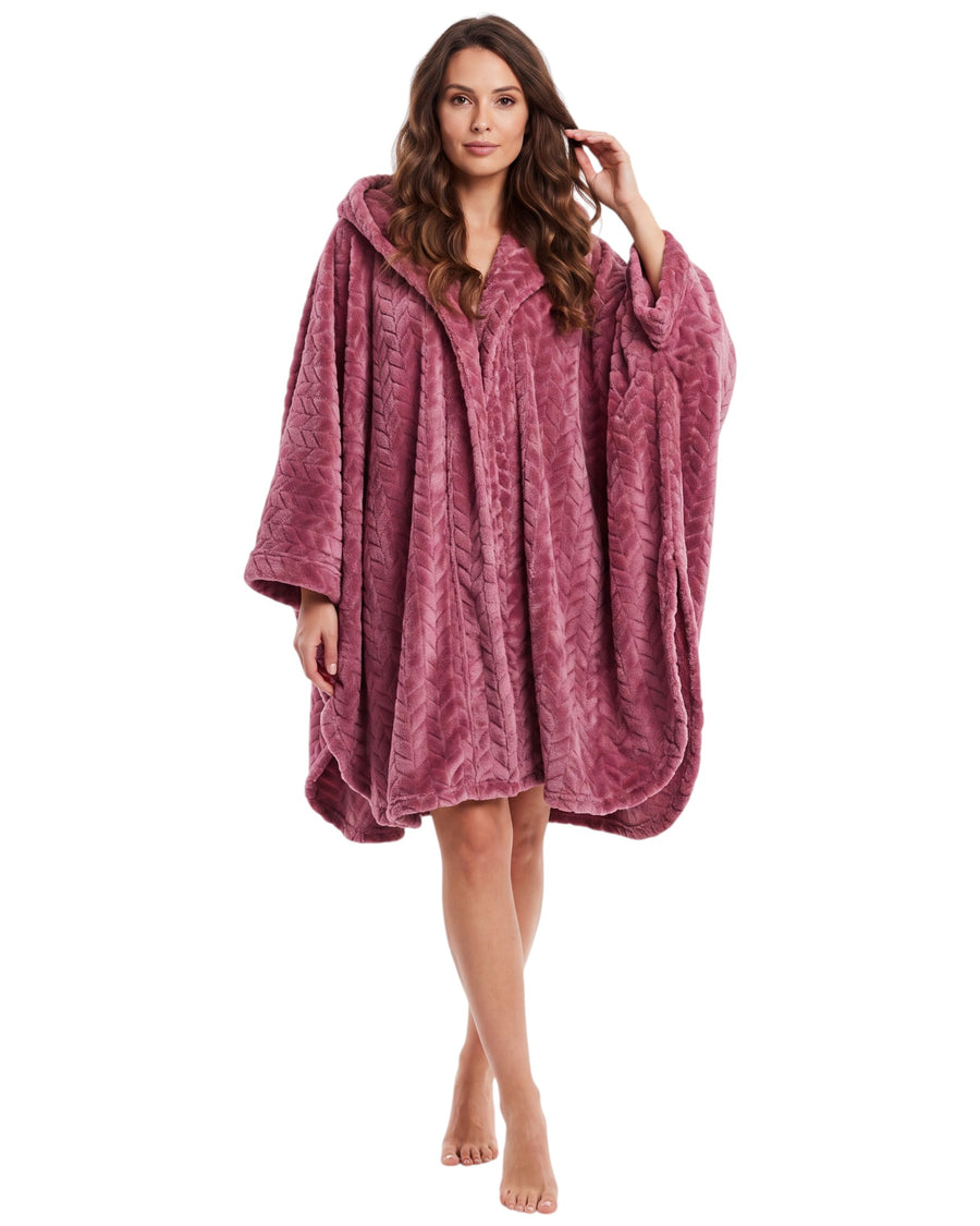 A woman modeling a dusty rose pink hooded robe with a textured chevron pattern